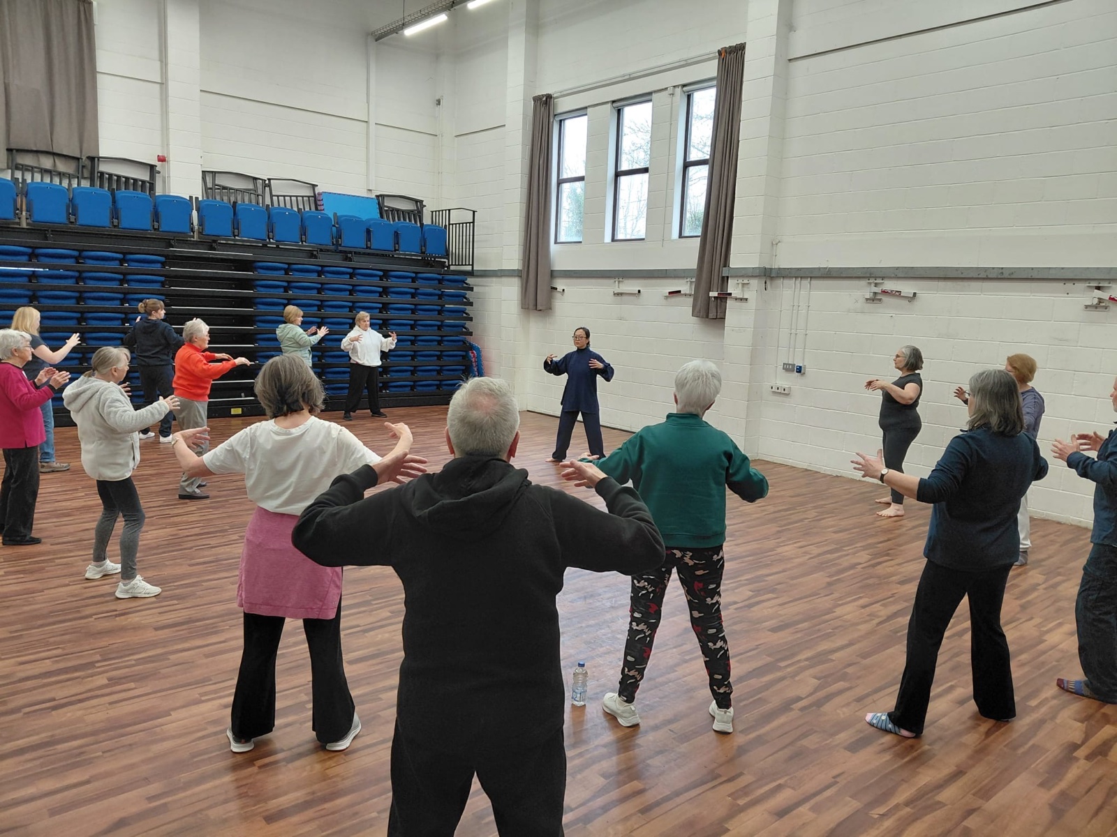 Dr Jar leading an inclusive public Tai Chi group session