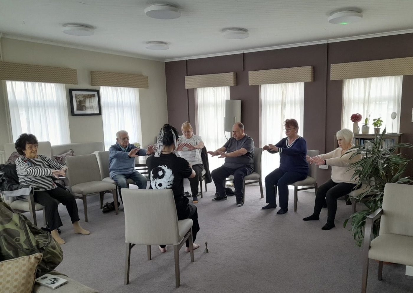 Dr Jar leading an inclusive seated community Tai Chi programme